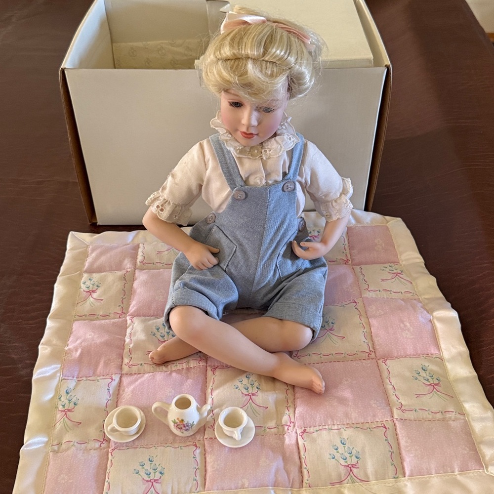 Porcelain Doll with Pink Quilt and Tea Set